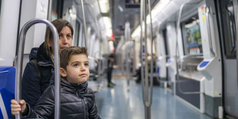 Mother and son travelling on the subway